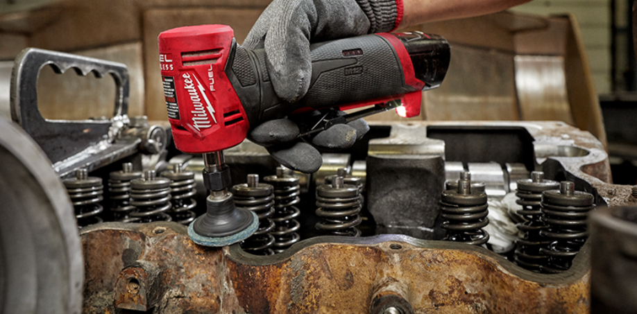 A Milwaukee M12 Die Grinder polishing parts of an engine