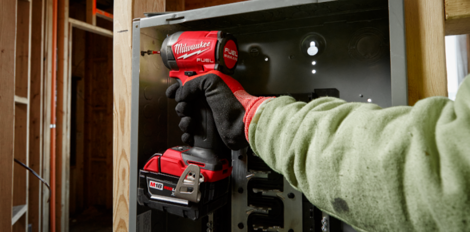 Milwaukee M18 Impact Driver drilling a screw into a piece of wood