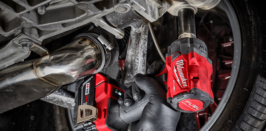 A picture of a Milwaukee M18 impact wrench tightening a car bolt