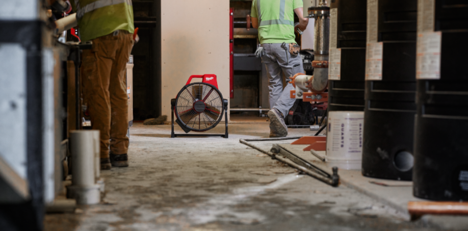 A picture of a Milwaukee M18 Fan in the distance on a jobsite