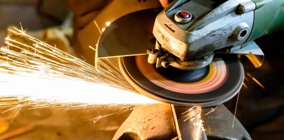 A picture of a grinding wheel grinding a piece of steel