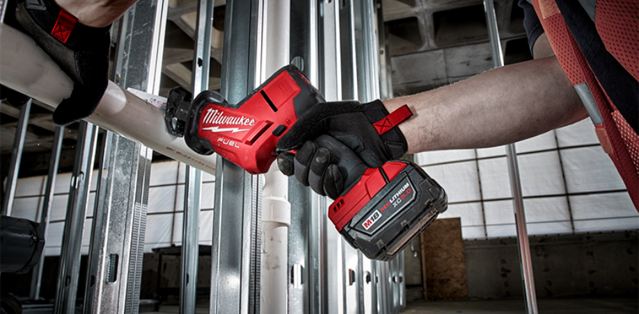 A worker using a Milwaukee Hackzall to cut a PVC pipe