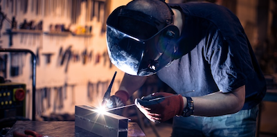 A picture of someone welding a piece of metal