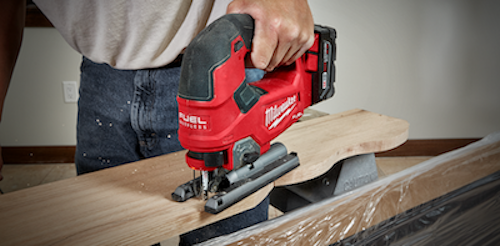 A picture of someone using a milwaukee jigsaw to cut a piece of wood