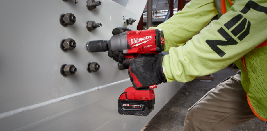 A picture of someone using a Milwaukee impact wrench to fasten bolts