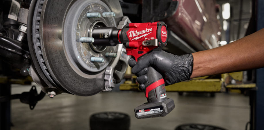 A picture of a Milwaukee impact wrench loosing bolts a on a car