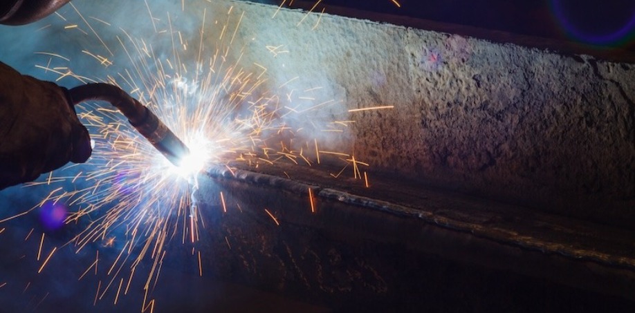 A person welding on a piece of steel