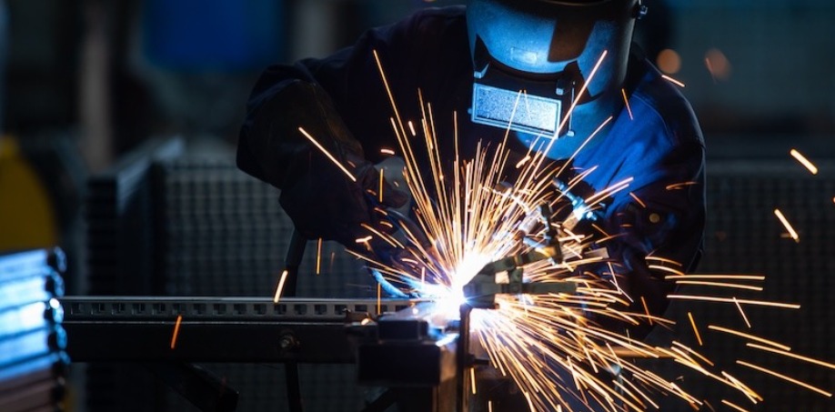 Someone welding a piece of steel together