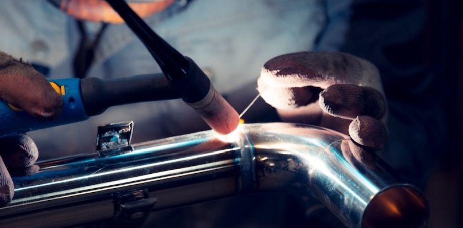 Someone TIG welding a piece of metal together