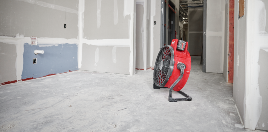 A dirty Milwaukee Jobsite Fan in an unfinished room