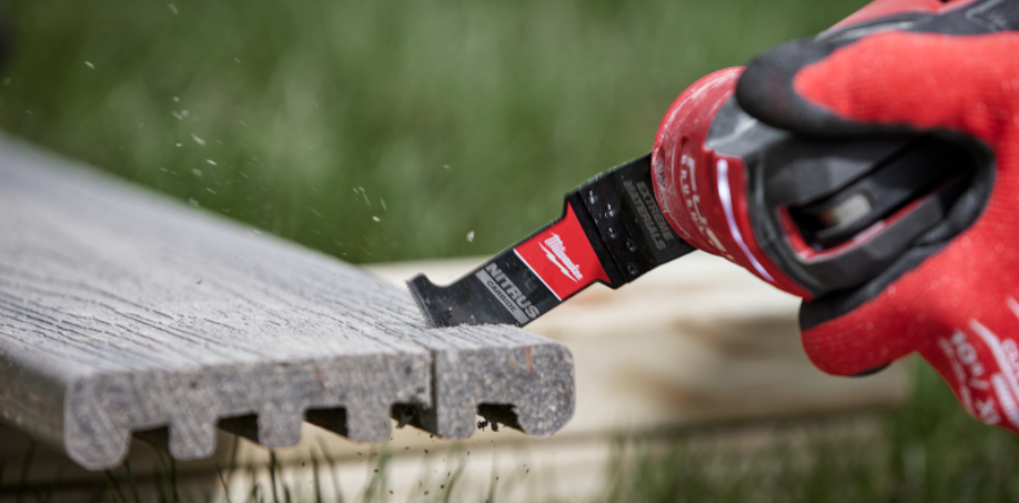 A Milwaukee M18 Multi-Tool cutting trex decking