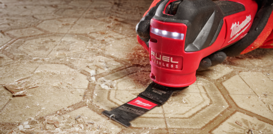 A Milwaukee multi-tool removing tile