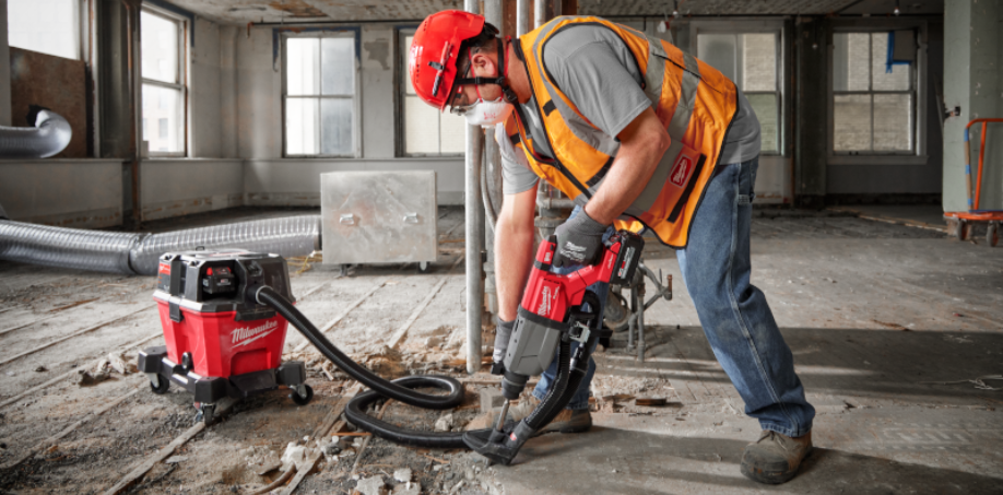 A man using a Rotary Hammer to break up a concrete floor