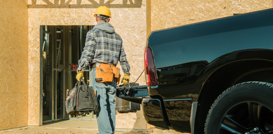 A man carrying his tool bag onto a construction site